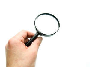 hand with magnifying glass